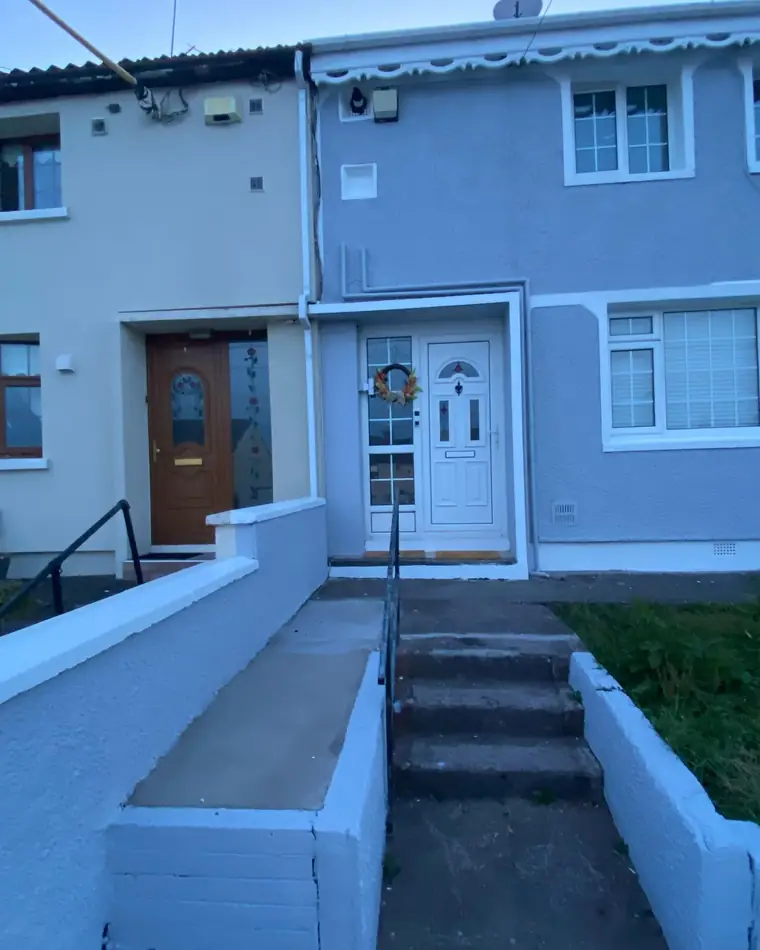 The same terrace from the path, grey render with white steps and walls