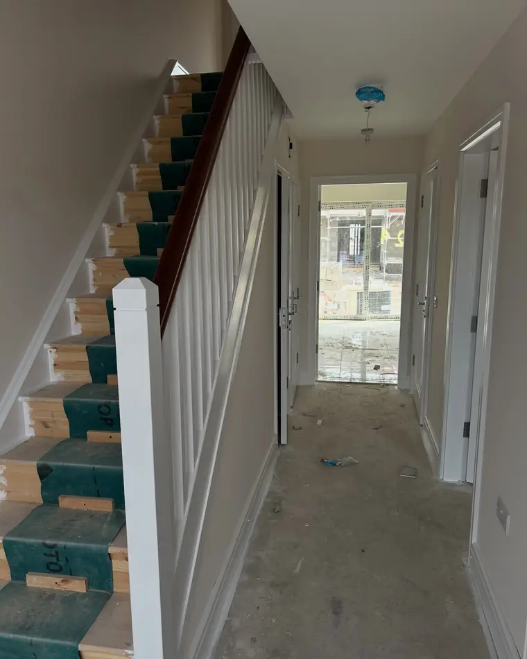New build hall and stairs with the treads covered and the walls finished