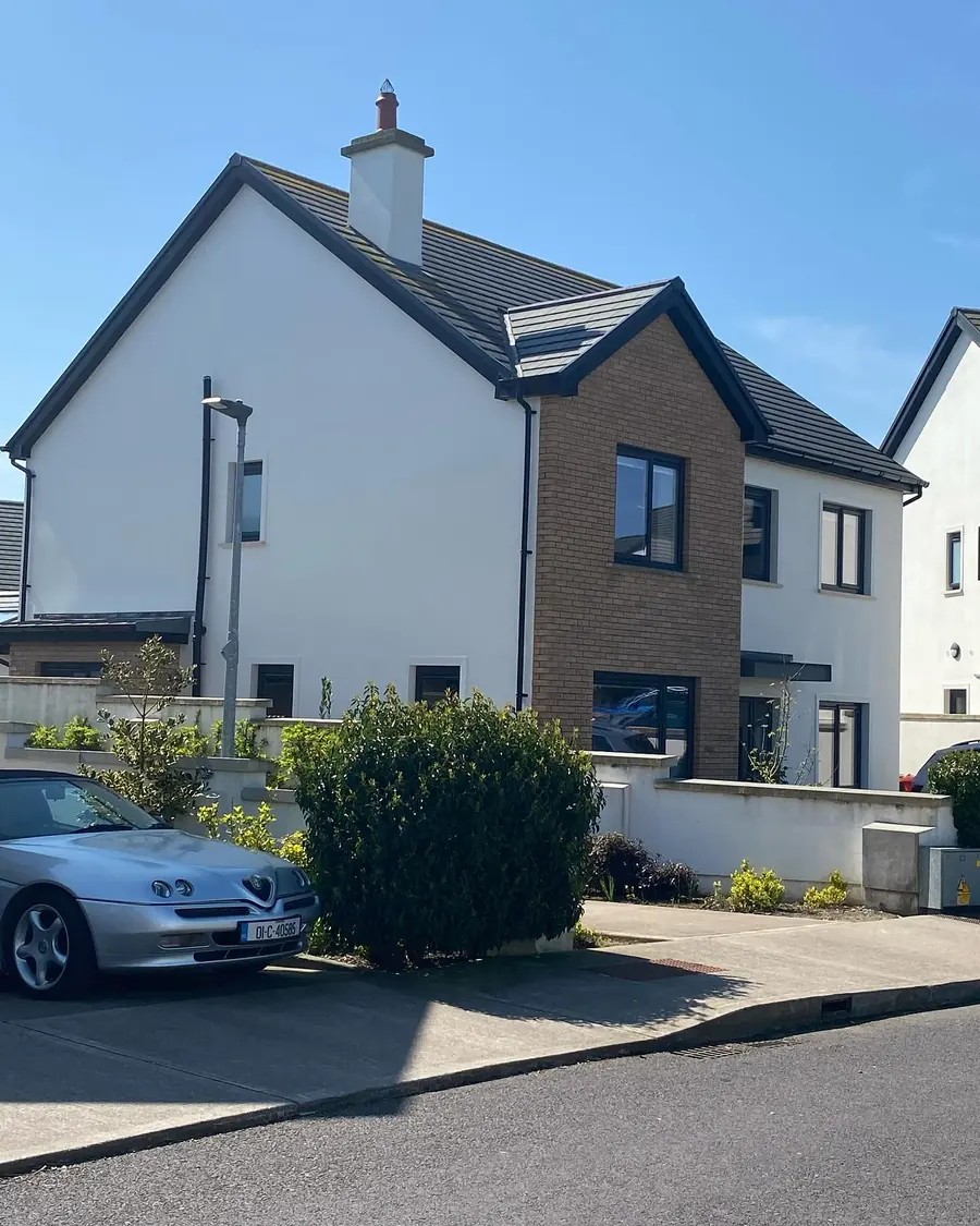 House exterior finished in almond white on a bright day