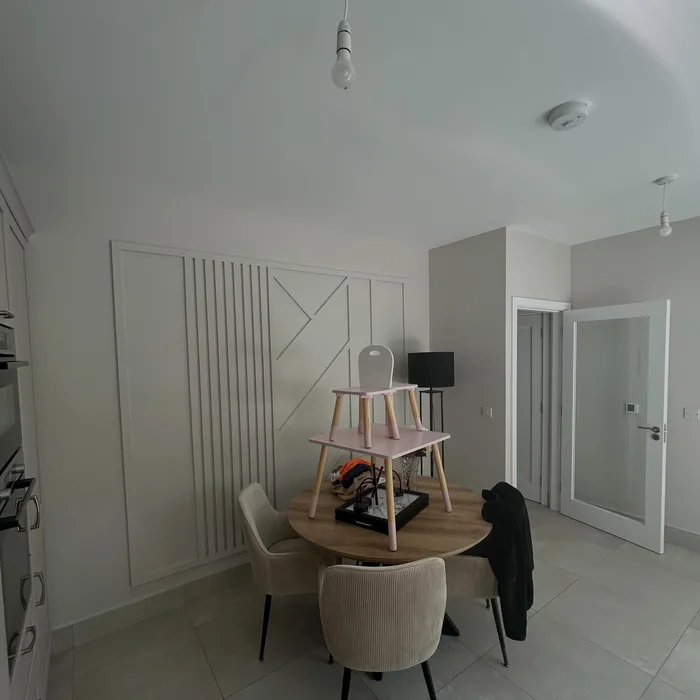 Dining area with a fluted feature wall painted in off white
